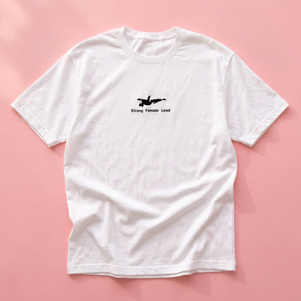 Flat lay with only the Orca tee on pink
